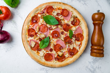 Italian meat pizza with cheese and tomato sauce with basil top view