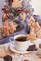 Aesthetic winter breakfast. Ginger cookies of snowflake near Christmas tree. Cozy warm home