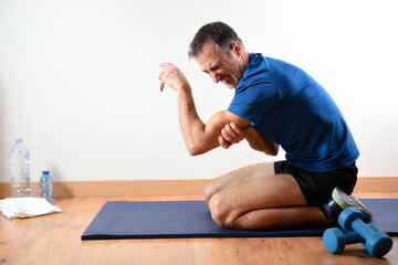 Man doing sport indoors complaining with triceps pain
