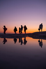 A fun family by the lake at sunset, reflection and silhouette, golden hours, Pamukkale travertines - Denizli