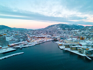 Fototapeta na wymiar Sunset over the snow covered town center of Osøyro, Bjørnafjorden, Norway