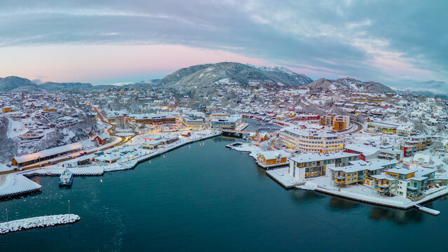 Sunset over the snow covered town center of Os&oslash;yro, Bj&oslash;rnafjorden, Norway