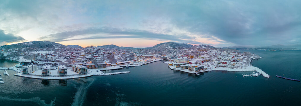 Sunset over the snow covered town center of Os&oslash;yro, Bj&oslash;rnafjorden, Norway