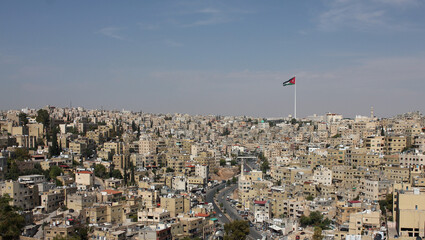 Huge Jordan flag in midtown Amman, landscape view of clear sky background