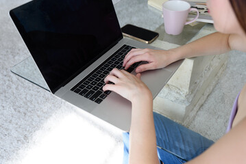 Girl typing on laptop computer