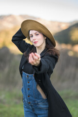 Smiling girl with hand stretched toward camera