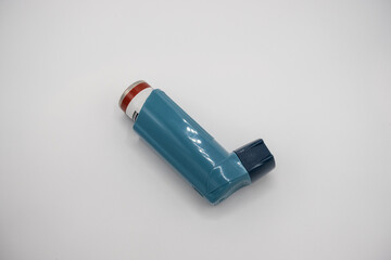 Selective focus on a blue inhaler on a white background