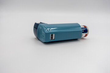 Selective focus on a blue inhaler on a white background