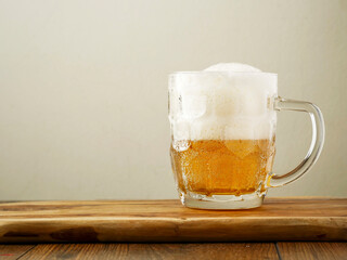 Beer mug half full and tall froth. Lager in a glass.