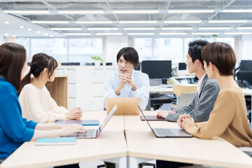 オフィスで打ち合わせをする人々