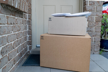 Parcel boxes delivered to a front door of residential building. Online shopping and delivery