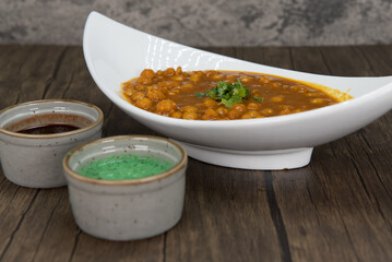 Traditional Indian meal starts with a delicious bowl of chana masala with humus dipping sauce for extra flavor