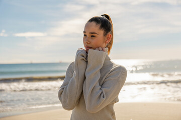 Portrait of a young pretty girl on the background of the sea