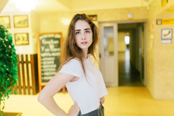 young woman standing next to an open door