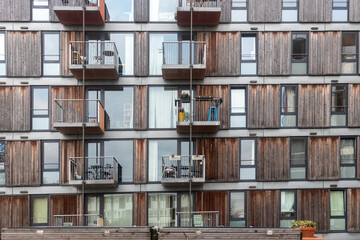 fragment of a facade of a building with balcony with table and chair