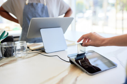Cropped hand on woman inserting credit card in modern POS system