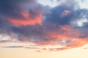 Beautiful sunset sky. Clouds illuminated by red sunlight at sunset. This view of the sky with clouds at sunset is great for background and design.
