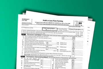 Form 1040 (Schedule F) documentation published IRS USA 12.16.2020. American tax document on colored