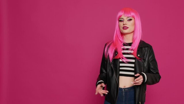 Happy confident girl with leather jacket waving on online video call, talking to people on remote internet conference. Cheerful stylish person looking at webcam and chatting on videoconference.