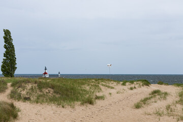 Fototapeta na wymiar Sand beach with St. Joseph North Pier Lighthouse and St. Joseph North Pierhead Outer Lighthouse in background
