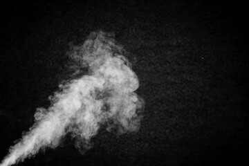 Abstract white smoke or steam on dark
