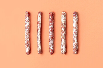 Flat lay of mini fuet snack sticks on the beige background