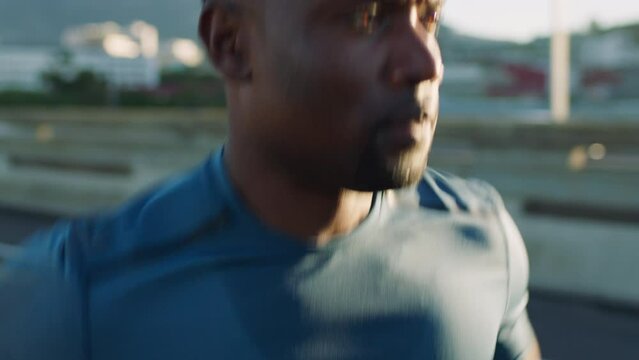Fitness, workout and black man running in the city for endurance, speed and health exercise. Sports, athlete and African runner doing cardio training for race or marathon in the street of urban town.