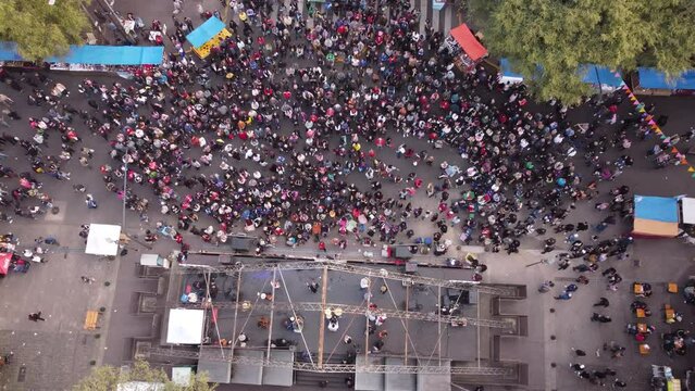 The partying people with folk dance in front of the stage of the feria de Mataderos in Buenos Aires Chacarera in Argentina