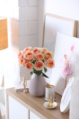 Vase with beautiful flowers on chest of drawers in modern room interior