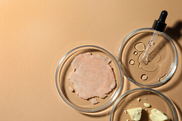 Flat lay composition with Petri dishes on beige background. Space for text