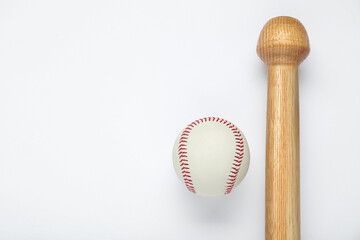 Wooden baseball bat and ball on white background, top view with space for text. Sports equipment