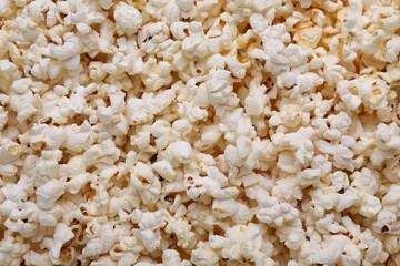 Tasty pop corn as background, top view