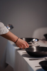 hand with a plate putting on table