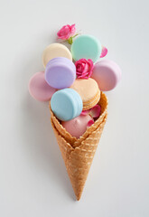 Photo of color containers for cosmetic products in waffle cone on the white table