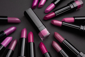 Set of color lipsticks, studio photo on black background. Fashion colorful lipsticks. Professional make up and beauty.