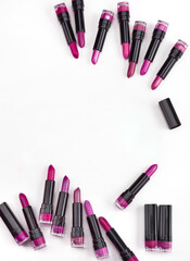 Set of lipsticks of pink shades on white background