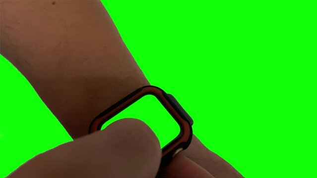 Man hands gestures a modern smart watch with a green screen chroma key content 4K