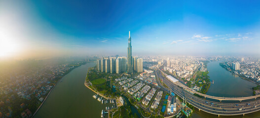 Aerial sunrise view at Landmark 81 - it is a super tall skyscraper and Saigon bridge with...