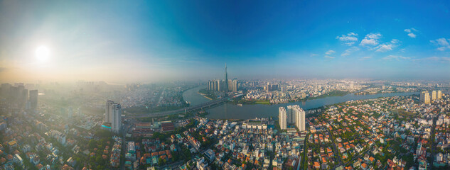 Aerial sunrise view at Landmark 81 - it is a super tall skyscraper and Saigon bridge with...