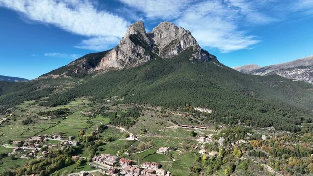 Stunning Pedraforca mountain aerial view across Saldes village woodland landscape towards rocky pitchfork peak