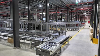 Parcels move on conveyor belt in empty automated sorting center