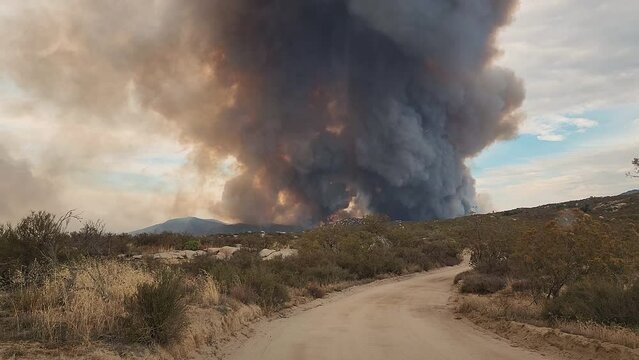 View of California wildfire deadly smoke going up in the sky through the foothills of Riverside County, Valle Vista, USA
