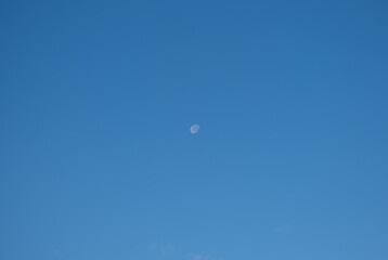 The moon in the clear blue daylight