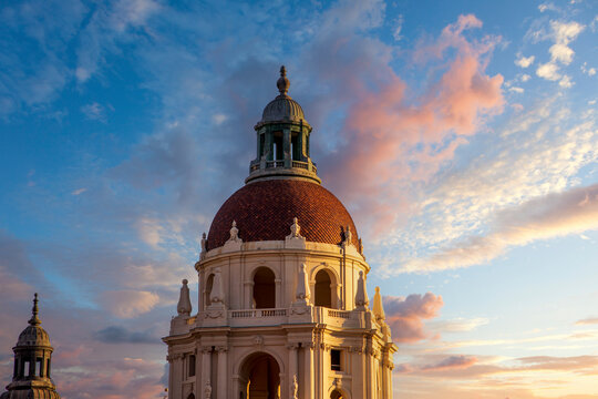 the bell tower on the city hall buildings covered in red brick with powerful clouds at sunset in Pasadena California USA