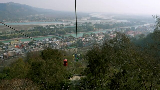 rope way running through green forests to mountain top video is taken at Mansa Devi Temple rope way haridwar uttrakhand india on Mar 15 2022.