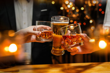 food and drink male friends are happy drinking beer and clinking glasses at a bar or pub.