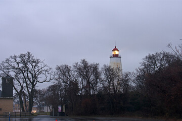 Lighthouse in Sandy Hook, New Jersey, at dusk, with the light turned on -81