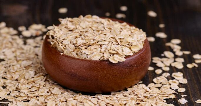 Put a wooden bowl with oatmeal on the table, a bowl filled with oatmeal on the table