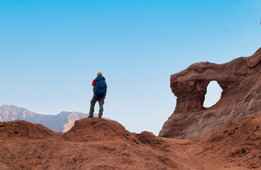 Hiker with backpack enjoy the landscape on deserted mountains - The Window in the Rock (Las Ventanas in spanish) in Cafayate, Salta, Argentina - Adventure travel concept