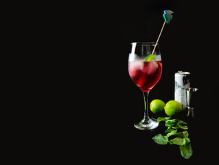 Tropical drink cranberry, mint, lime and ice in dark background. Copyspace space for text